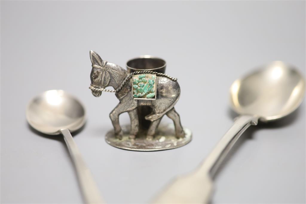 A novelty 900 white metal donkey match holder, a Victorian silver fiddle pattern dessert spoon and another silver spoon,